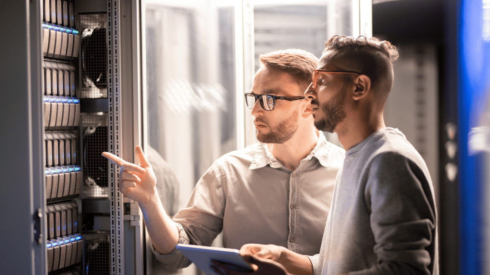 two male technicians looking at a server