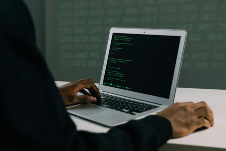 person sitting with a laptop