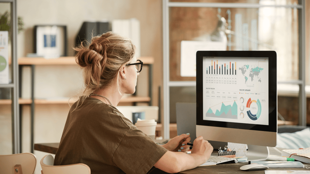 woman looking at graphs on her computer