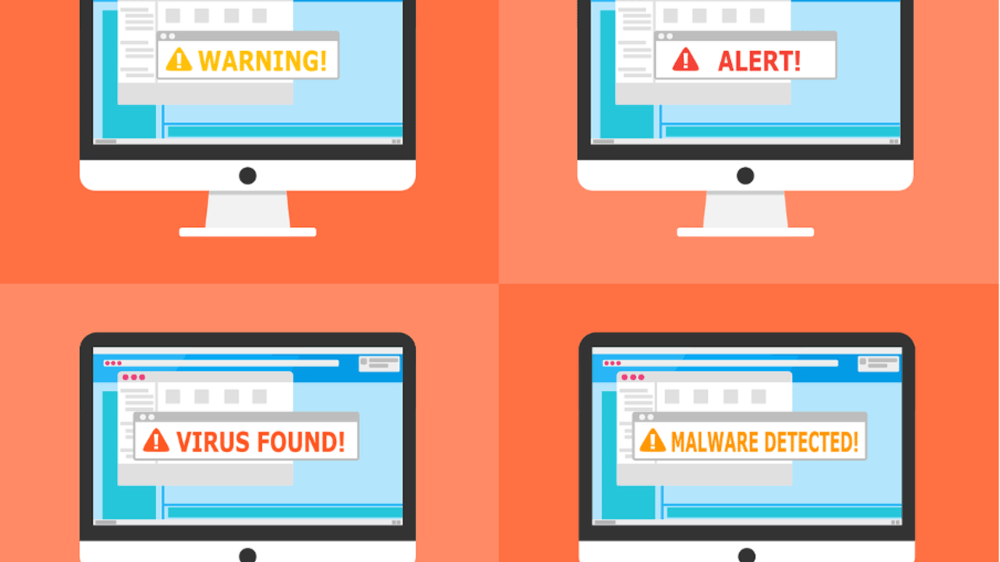 computer monitors with warning signs popping up on the screen