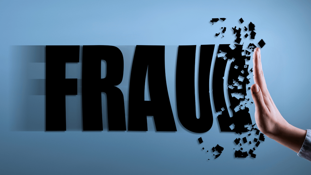 lettering spelling fraud with a hand blocking it