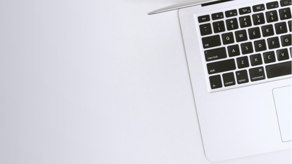 laptop sitting on a white desk